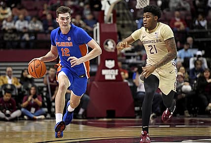 Nov 18, 2022; Tallahassee, Florida, USA; Florida Gators forward Colin Castleton (12) drives up the court past Florida State Seminoles guard Cam'Ron Fletcher (21) during the second half at Donald L. Tucker Center. Mandatory Credit: Melina Myers-USA TODAY Sports