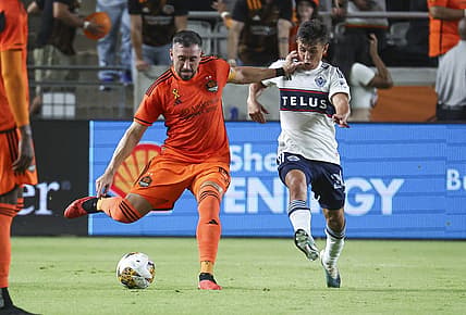 Sep 20, 2023; Houston, Texas, USA; Houston Dynamo FC midfielder Hector Herrera (16) kicks the ball as Vancouver Whitecaps FC midfielder Andres Cubas (20) defends during the first half at Shell Energy Stadium. Mandatory Credit: Troy Taormina-USA TODAY Sports