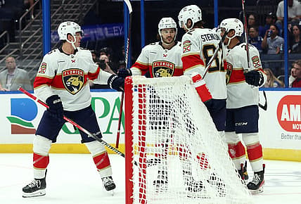 Oct 5, 2023; Tampa, Florida, USA; Florida Panthers left wing Ryan Lomberg (94) is congratulated after he scored a goal against the Tampa Bay Lightning  during the third period at Amalie Arena. Mandatory Credit: Kim Klement Neitzel-USA TODAY Sports