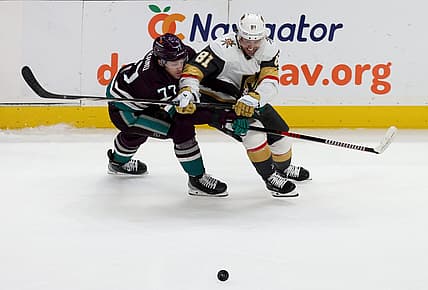 Nov 5, 2023; Anaheim, California, USA; Anaheim Ducks right wing Frank Vatrano (77) and Vegas Golden Knights right wing Jonathan Marchessault (81) battle for the puck during the second period at Honda Center. Mandatory Credit: Jason Parkhurst-USA TODAY Sports