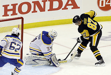 Mar 24, 2021; Pittsburgh, Pennsylvania, USA; Buffalo Sabres goaltender Dustin Tokarski (31) makes a save against Pittsburgh Penguins center Sidney Crosby (87) during the second period at PPG Paints Arena. Mandatory Credit: Charles LeClaire-USA TODAY Sports