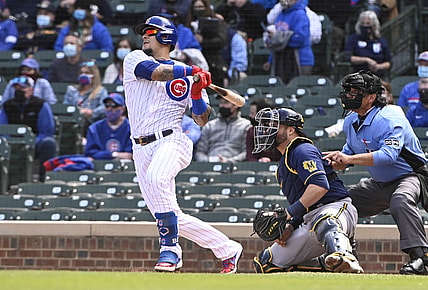 Apr 23, 2021; Chicago, Illinois, USA; Chicago Cubs shortstop Javier Baez (9) hits a home run against the Milwaukee Brewers in the second inning  at Wrigley Field. Mandatory Credit: Matt Marton-USA TODAY Sports