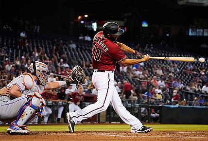 Jun 2, 2021; Phoenix, Arizona, USA; Arizona Diamondbacks starting pitcher Madison Bumgarner (40) hits an RBI-single off New York Mets starting pitcher David Peterson (23) in the first inning at Chase Field. Mandatory Credit: Rob Schumacher-Arizona Republic

Mlb N Y Mets At Arizona Diamondbacks