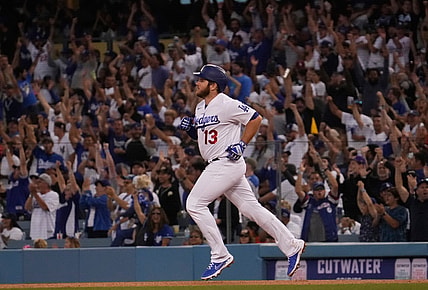Jun 29, 2021; Los Angeles, California, USA; Fans cheer as Los Angeles Dodgers first baseman Max Muncy (13) rounds the bases after hitting a home run in the fourth inning against the San Francisco Giants at Dodger Stadium. Mandatory Credit: Robert Hanashiro-USA TODAY Sports