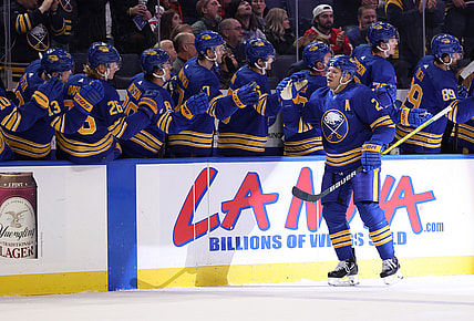 Feb 15, 2022; Buffalo, New York, USA;  Buffalo Sabres right wing Kyle Okposo (21) celebrates his goal with teammates during the first period against the New York Islanders at KeyBank Center. Mandatory Credit: Timothy T. Ludwig-USA TODAY Sports