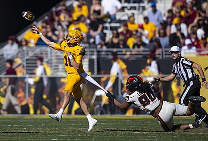 Nov 19, 2022; Tempe, Arizona, USA; Arizona State Sun Devils quarterback Trenton Bourguet (16) throws a pass under pressure from Oregon State Beavers defensive lineman Sione Lolohea (90) during the first half at Sun Devil Stadium. Mandatory Credit: Mark J. Rebilas-USA TODAY Sports