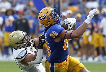 Sep 2, 2023; Pittsburgh, Pennsylvania, USA;  Pittsburgh Panthers tight end Gavin Bartholomew (86) makes a catch as Wofford Terriers linebacker David Powers (34) during the second quarter at Acrisure Stadium. Mandatory Credit: Charles LeClaire-USA TODAY Sports