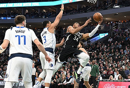 Nov 18, 2023; Milwaukee, Wisconsin, USA; Milwaukee Bucks forward Giannis Antetokounmpo (34) drives to the basket against Dallas Mavericks forward Grant Williams (3) in the first half at Fiserv Forum. Mandatory Credit: Michael McLoone-USA TODAY Sports