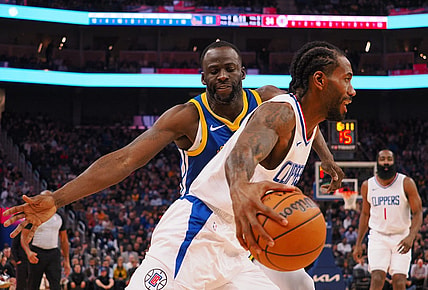 Nov 30, 2023; San Francisco, California, USA; Los Angeles Clippers forward Kawhi Leonard (2) controls the ball against Golden State Warriors forward Draymond Green (23) during the second quarter at Chase Center. Mandatory Credit: Kelley L Cox-USA TODAY Sports