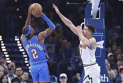 Jan 31, 2024; Oklahoma City, Oklahoma, USA; Oklahoma City Thunder guard Shai Gilgeous-Alexander (2) shoots as Denver Nuggets forward Michael Porter Jr. (1) defends during the first quarter at Paycom Center. Mandatory Credit: Alonzo Adams-USA TODAY Sports