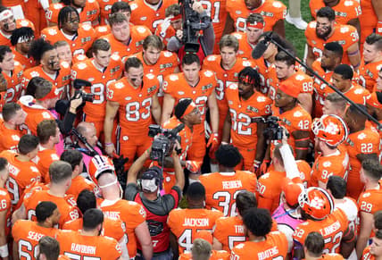 Clemson Tigers football players huddle