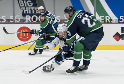 Feb 19, 2021; Vancouver, British Columbia, CAN; Vancouver Canucks defenseman Alexander Edler (23) checks Winnipeg Jets forward Nikolaj Ehlers (27) in the second period at Rogers Arena. Mandatory Credit: Bob Frid-USA TODAY Sports