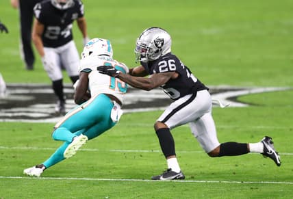 Dec 26, 2020; Paradise, Nevada, USA; Miami Dolphins wide receiver Jakeem Grant (19) is tackled by Las Vegas Raiders cornerback Nevin Lawson (26) at Allegiant Stadium. Mandatory Credit: Mark J. Rebilas-USA TODAY Sports