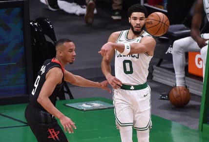 Apr 2, 2021; Boston, Massachusetts, USA;  Boston Celtics forward Jayson Tatum (0) passes the ball past Houston Rockets guard Avery Bradley (9) during the first half at TD Garden. Mandatory Credit: Bob DeChiara-USA TODAY Sports
