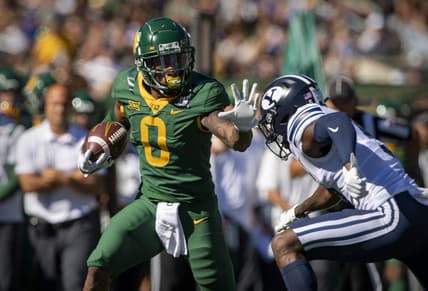 Oct 16, 2021; Waco, Texas, USA; Baylor Bears wide receiver R.J. Sneed (0) stiff arms Brigham Young Cougars defensive back D'Angelo Mandell (5) during the first quarter at McLane Stadium. Mandatory Credit: Jerome Miron-USA TODAY Sports