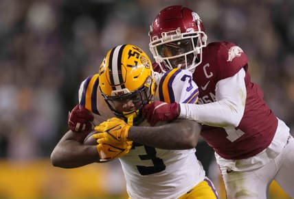Nov 13, 2021; Baton Rouge, Louisiana, USA; LSU Tigers running back Tyrion Davis-Price (3) runs the ball against Arkansas Razorbacks defensive back Joe Foucha (7) in the first half at Tiger Stadium. Mandatory Credit: Kirby Lee-USA TODAY Sports