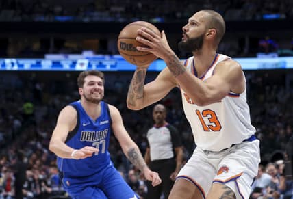 Mar 9, 2022; Dallas, Texas, USA;  New York Knicks guard Evan Fournier (13) shoots past Dallas Mavericks guard Luka Doncic (77) during the second half at American Airlines Center. Mandatory Credit: Kevin Jairaj-USA TODAY Sports