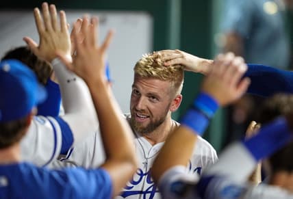 Sep 20, 2022; Kansas City, Missouri, USA; Kansas City Royals first baseman Hunter Dozier (17) is congratulated by teammates after hitting a home run during the fifth inning against the Minnesota Twins at Kauffman Stadium. Mandatory Credit: Jay Biggerstaff-USA TODAY Sports