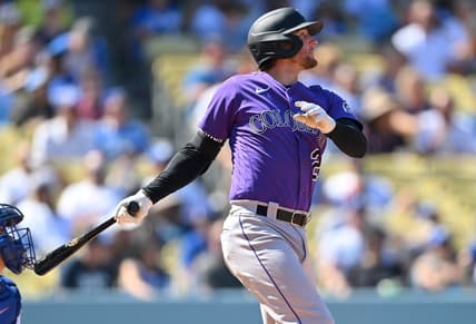 Oct 2, 2022; Los Angeles, California, USA;  Colorado Rockies third baseman Ryan McMahon (24) hits a RBI double in the third inning against the Los Angeles Dodgers at Dodger Stadium. Mandatory Credit: Jayne Kamin-Oncea-USA TODAY Sports
