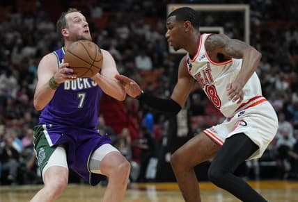 Jan 14, 2023; Miami, Florida, USA; Milwaukee Bucks guard Joe Ingles (7) shoots the ball against Miami Heat forward Jamal Cain (8) during the first half at Miami-Dade Arena. Mandatory Credit: Jim Rassol-USA TODAY Sports