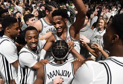 Feb 8, 2023; Nashville, Tennessee, USA; Vanderbilt Commodores guard Tyrin Lawrence (0) celebrates with teammates and fans after a win against the Tennessee Volunteers at Memorial Gymnasium. Mandatory Credit: Christopher Hanewinckel-USA TODAY Sports