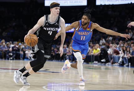 Feb 28, 2023; Oklahoma City, Oklahoma, USA; Sacramento Kings guard Kevin Huerter (9) drives to the basket around Oklahoma City Thunder guard Isaiah Joe (11) during the first quarter at Paycom Center. Mandatory Credit: Alonzo Adams-USA TODAY Sports
