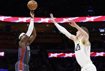 Mar 3, 2023; Oklahoma City, Oklahoma, USA; Oklahoma City Thunder guard Luguentz Dort (5) shoots a three point basket against Utah Jazz forward Lauri Markkanen (23) during the first quarter at Paycom Center. Mandatory Credit: Alonzo Adams-USA TODAY Sports