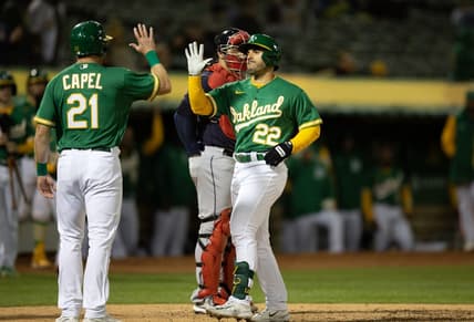 Apr 3, 2023; Oakland, California, USA; Oakland Athletics designated hitter Ram  n Laureano (22) is greeted by teammate Conner Capel (21) after hitting a two-run home run against the Cleveland Guardians during the fifth inning at RingCentral Coliseum. Mandatory Credit: D. Ross Cameron-USA TODAY Sports