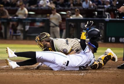 Apr 20, 2023; Phoenix, Arizona, USA; Arizona Diamondbacks base runner Geraldo Perdomo (2) scores ahead of the tag by San Diego Padres catcher Austin Nola in the fourth inning at Chase Field. Mandatory Credit: Mark J. Rebilas-USA TODAY Sports