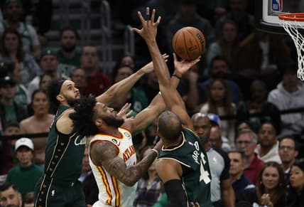 Apr 25, 2023; Boston, Massachusetts, USA; Atlanta Hawks forward Saddiq Bey (41) goes between Boston Celtics center Al Horford (42) and guard Derrick White (9) during the second quarter of game five of the 2023 NBA playoffs at TD Garden. Mandatory Credit: Winslow Townson-USA TODAY Sports