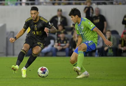 Jun 21, 2023; Los Angeles, California, USA; Los Angeles FC forward Denis Bouanga (99) dribbles the ball past Seattle Sounders midfielder Obed Vargas (73) during the first half at BMO Stadium. Mandatory Credit: Jayne Kamin-Oncea-USA TODAY Sports
