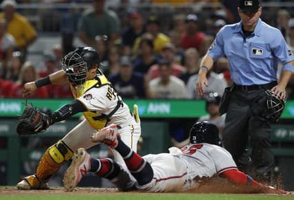 Aug 9, 2023; Pittsburgh, Pennsylvania, USA;  Atlanta Braves center fielder Michael Harris II (right) scores a run past Pittsburgh Pirates catcher Endy Rodriguez (25) during the eighth inning at PNC Park. Mandatory Credit: Charles LeClaire-USA TODAY Sports
