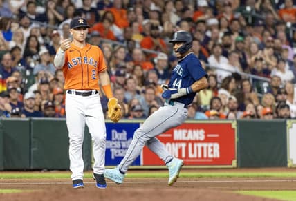 Aug 18, 2023; Houston, Texas, USA; Seattle Mariners center fielder Julio Rodriguez (44) runs from first base to third base on an error as Houston Astros third baseman Alex Bregman (2) awaits the throw in the seventh inning at Minute Maid Park. Mandatory Credit: Thomas Shea-USA TODAY Sports
