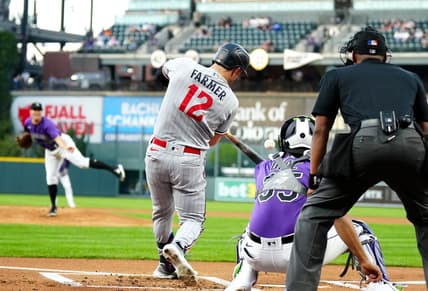 Sep 29, 2023; Denver, Colorado, USA; Minnesota Twins short stop Kyle Farmer (12) RBI singles in the first inning against the Colorado Rockies at Coors Field. Mandatory Credit: Ron Chenoy-USA TODAY Sports