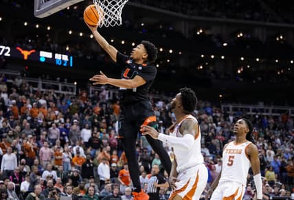 Mar 26, 2023; Kansas City, MO, USA; Miami (Fl) Hurricanes guard Nijel Pack (24) shoots against Texas Longhorns guard Tyrese Hunter (4) and guard Marcus Carr (5) during the second half of an Elite 8 college basketball game in the Midwest Regional of the 2023 NCAA Tournament at T-Mobile Center. Mandatory Credit: Jay Biggerstaff-USA TODAY Sports