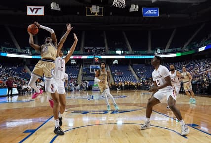 Mar 7, 2023; Greensboro, NC, USA; Georgia Tech Yellow Jackets guard Miles Kelly (13) goes up for a shot against Florida State Seminoles forward Cam Corhen (3) during the second half of the first round of the ACC tournament at Greensboro Coliseum. Mandatory Credit: John David Mercer-USA TODAY Sports