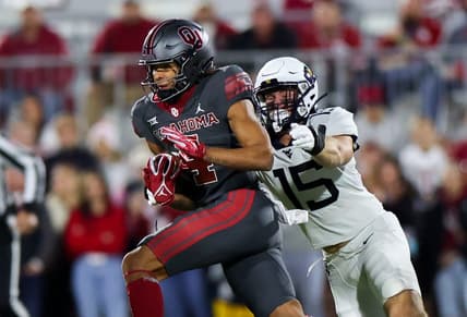 Nov 11, 2023; Norman, Oklahoma, USA;  Oklahoma Sooners wide receiver Nic Anderson (4) runs with the ball as West Virginia Mountaineers linebacker Ben Cutter (15) defends during the first quarter at Gaylord Family-Oklahoma Memorial Stadium. Mandatory Credit: Kevin Jairaj-USA TODAY Sports