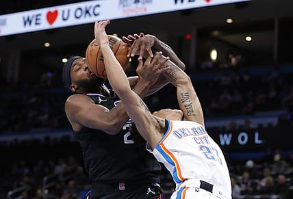 Dec 18, 2021; Oklahoma City, Oklahoma, USA; Oklahoma City Thunder guard Tre Mann (23) and LA Clippers forward Justise Winslow (20) battle for a loose ball during the second quarter at Paycom Center. Mandatory Credit: Alonzo Adams-USA TODAY Sports