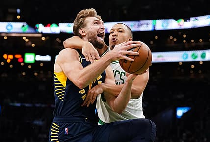 Jan 10, 2022; Boston, Massachusetts, USA; Boston Celtics forward Grant Williams (12) fouls Indiana Pacers forward Domantas Sabonis (11) in the second quarter at TD Garden. Mandatory Credit: David Butler II-USA TODAY Sports