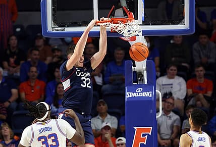 Dec 7, 2022; Gainesville, Florida, USA; Connecticut Huskies center Donovan Clingan (32) dunks against the Florida Gators during the first half at Exactech Arena at the Stephen C. O'Connell Center. Mandatory Credit: Kim Klement-USA TODAY Sports