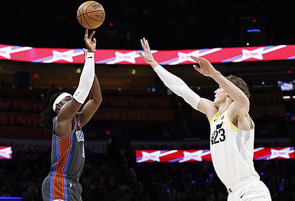 Mar 3, 2023; Oklahoma City, Oklahoma, USA; Oklahoma City Thunder guard Luguentz Dort (5) shoots a three point basket against Utah Jazz forward Lauri Markkanen (23) during the first quarter at Paycom Center. Mandatory Credit: Alonzo Adams-USA TODAY Sports