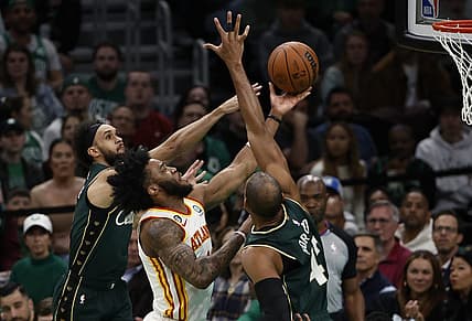 Apr 25, 2023; Boston, Massachusetts, USA; Atlanta Hawks forward Saddiq Bey (41) goes between Boston Celtics center Al Horford (42) and guard Derrick White (9) during the second quarter of game five of the 2023 NBA playoffs at TD Garden. Mandatory Credit: Winslow Townson-USA TODAY Sports