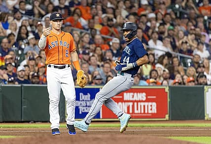 Aug 18, 2023; Houston, Texas, USA; Seattle Mariners center fielder Julio Rodriguez (44) runs from first base to third base on an error as Houston Astros third baseman Alex Bregman (2) awaits the throw in the seventh inning at Minute Maid Park. Mandatory Credit: Thomas Shea-USA TODAY Sports