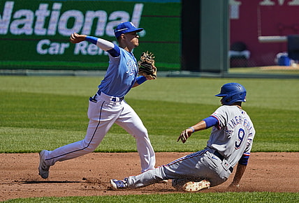 Apr 4, 2021; Kansas City, Missouri, USA; Kansas City Royals shortstop Nicky Lopez (8) throws to first base after forcing out Texas Rangers third baseman Isiah Kiner-Falefa (9) during the third inning at Kauffman Stadium. Mandatory Credit: Jay Biggerstaff-USA TODAY Sports