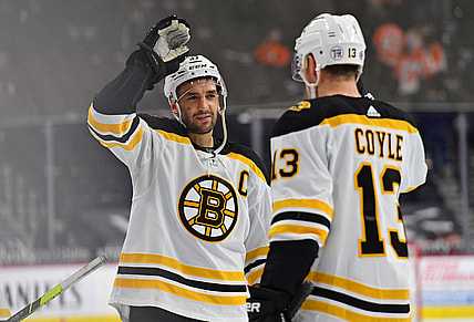 Apr 6, 2021; Philadelphia, Pennsylvania, USA; Boston Bruins center Patrice Bergeron (37) and center Charlie Coyle (13) celebrate win against the Philadelphia Flyers at Wells Fargo Center. Mandatory Credit: Eric Hartline-USA TODAY Sports