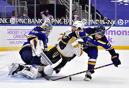Apr 7, 2021; St. Louis, Missouri, USA;  St. Louis Blues goaltender Jordan Binnington (50) and defenseman Justin Faulk (72) defend the net against Vegas Golden Knights center Chandler Stephenson (20) during the first period at Enterprise Center. Mandatory Credit: Jeff Curry-USA TODAY Sports