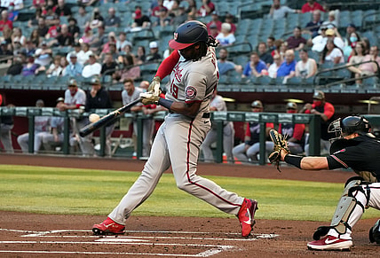May 14, 2021; Phoenix, Arizona, USA; Washington Nationals first baseman Josh Bell (19) hits a two run RBI double against the Arizona Diamondbacks in the first inning at Chase Field. Mandatory Credit: Rick Scuteri-USA TODAY Sports