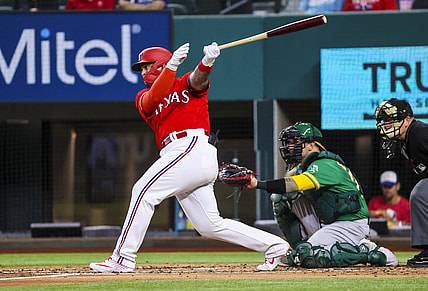 Aug 13, 2021; Arlington, Texas, USA;  Texas Rangers designated hitter Yohel Pozo (37) hits a single for his first major league hit during the second inning against the Oakland Athletics at Globe Life Field. Mandatory Credit: Kevin Jairaj-USA TODAY Sports