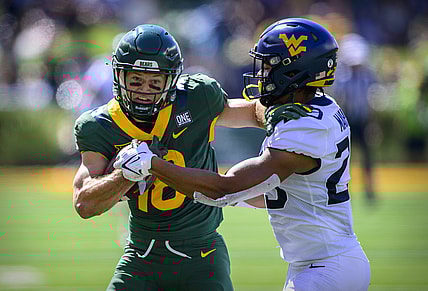 Oct 9, 2021; Waco, Texas, USA; Baylor Bears wide receiver Drew Estrada (18) stiff arms West Virginia Mountaineers safety Sean Mahone (29) during the first half at McLane Stadium. Mandatory Credit: Jerome Miron-USA TODAY Sports
