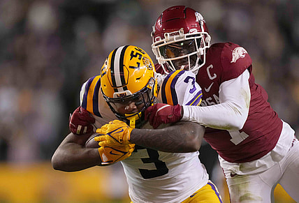 Nov 13, 2021; Baton Rouge, Louisiana, USA; LSU Tigers running back Tyrion Davis-Price (3) runs the ball against Arkansas Razorbacks defensive back Joe Foucha (7) in the first half at Tiger Stadium. Mandatory Credit: Kirby Lee-USA TODAY Sports